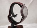 Angled three-quarter view of the Tissot RockWatch on a stand, highlighting the unique pattern of the stone case and dial.