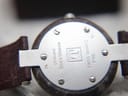 Close-up of the stainless steel case back of the RockWatch, showing 'GENUINE ROCKWATCH', 'SWISS QUARTZ', and 'R150' engravings.