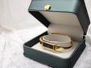 The Gucci 1500L watch displayed inside a green watch box on a white textured surface.