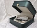 The Gucci 3900L watch presented in a dark green display box on a white textured background.