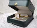 The Gucci 1900L watch presented within an open dark green jewellery box, featuring a gold crown emblem on the lid.