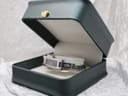 The Gucci 3900L watch displayed in an open, dark green presentation box with white interior.