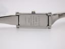 Case back of Gucci 1500L showing "Gucci 1500 L Swiss Made Stainless Steel" and serial number.