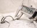 Digital caliper measuring the Gucci 1500L case width at 12.23mm.