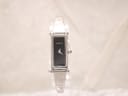 Front view of a silver Gucci 1500L watch with a black rectangular dial on a clear display stand.