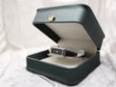 Gucci 1500L watch resting inside a dark green presentation box with a cream interior.
