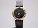 Front view of Gucci 3000 Jr watch with black dial, gold hands, and gold-plated case with Roman numeral bezel.