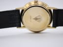 Close-up of the gold-plated case back of the Gucci 3000 Jr watch, showing Gucci crest and model engraving.