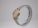 Side profile of the Gucci 9000 L watch, showcasing the gold-tone crown and the integrated bi-metal bracelet.