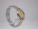 Another side view of the Gucci 9000 L watch, highlighting the curved case and the two-tone bracelet links.