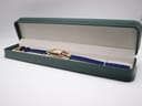 Gucci 1800 L watch with blue strap presented inside an open dark green watch box.