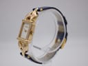 Angled view of the gold plated Gucci 1800 L watch, showing the right side of the rectangular case and blue leather strap.