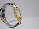 Angled view of the gold plated Gucci 1800 L watch, showing the left side of the rectangular case and blue leather strap.