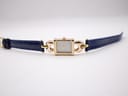 Full view of the Gucci 1800 L watch with the blue leather strap laid flat on a white surface.