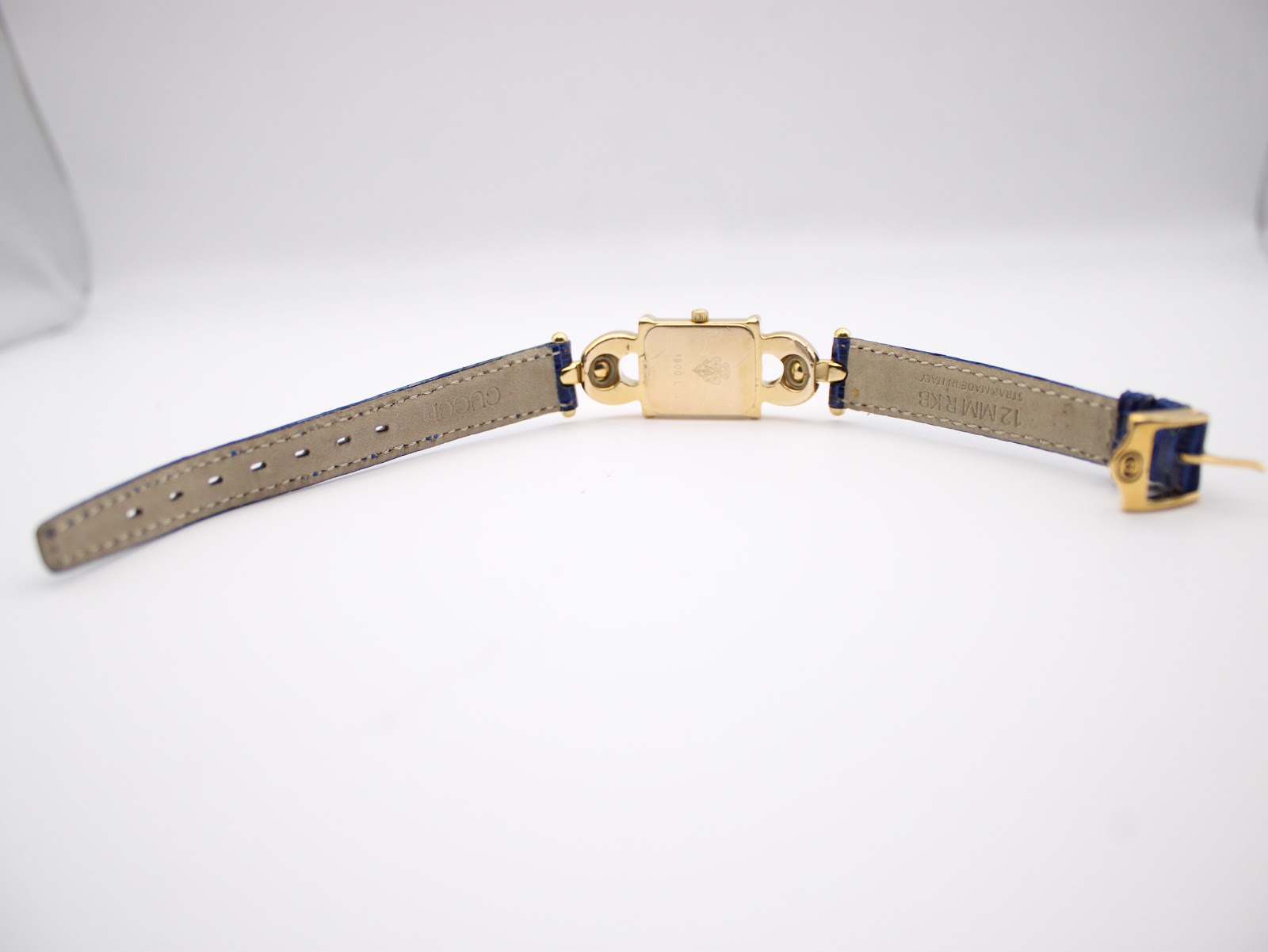 Full view of the Gucci 1800 L watch showing the case back and strap interior laid flat.