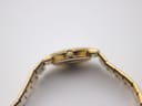 Full length view of the Gucci 3300L watch with its gold-plated bracelet extended, against a light background.