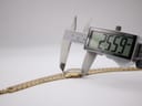The watch bracelet on a wrist sizing gauge, indicating a maximum wrist circumference of approximately 183mm, with a signed clasp visible.