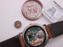 Front view of Gucci 8000.2.M watch with cream dial, gold hands, and brown leather strap.