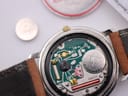 Side view of the Gucci watch showing gold-tone crown and two-tone stainless steel case.