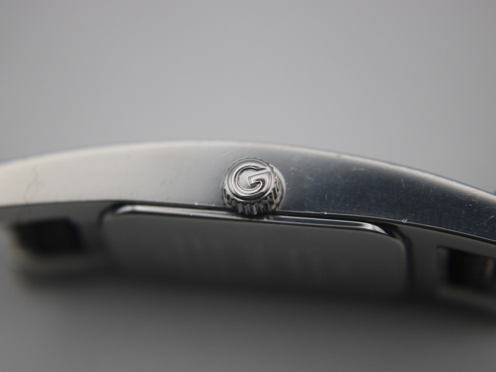 Close-up of the side of the watch showing the original Gucci-signed crown.