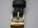 Close-up of the gold-tone buckle, clearly showing the 'GUCCI' engraving.