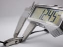 Digital caliper measuring the case width of the Gucci 3900L, displaying a precise reading of 12.45 mm.