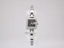 Front view of the Gucci G-Frame ladies' watch, stainless steel case and bracelet, black G-cutout dial, on a white background.