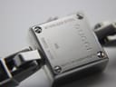 Close-up of the watch case back showing "Stainless Steel", "Gucci", "Swiss Made", "102", "10064991" serial, and "Water Resistant 3ATM" engravings.