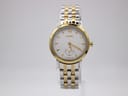 Front view of a Roamer 831.855 ladies watch on a clear stand, featuring a silver textured dial with gold hour markers and a two-tone stainless steel bracelet.