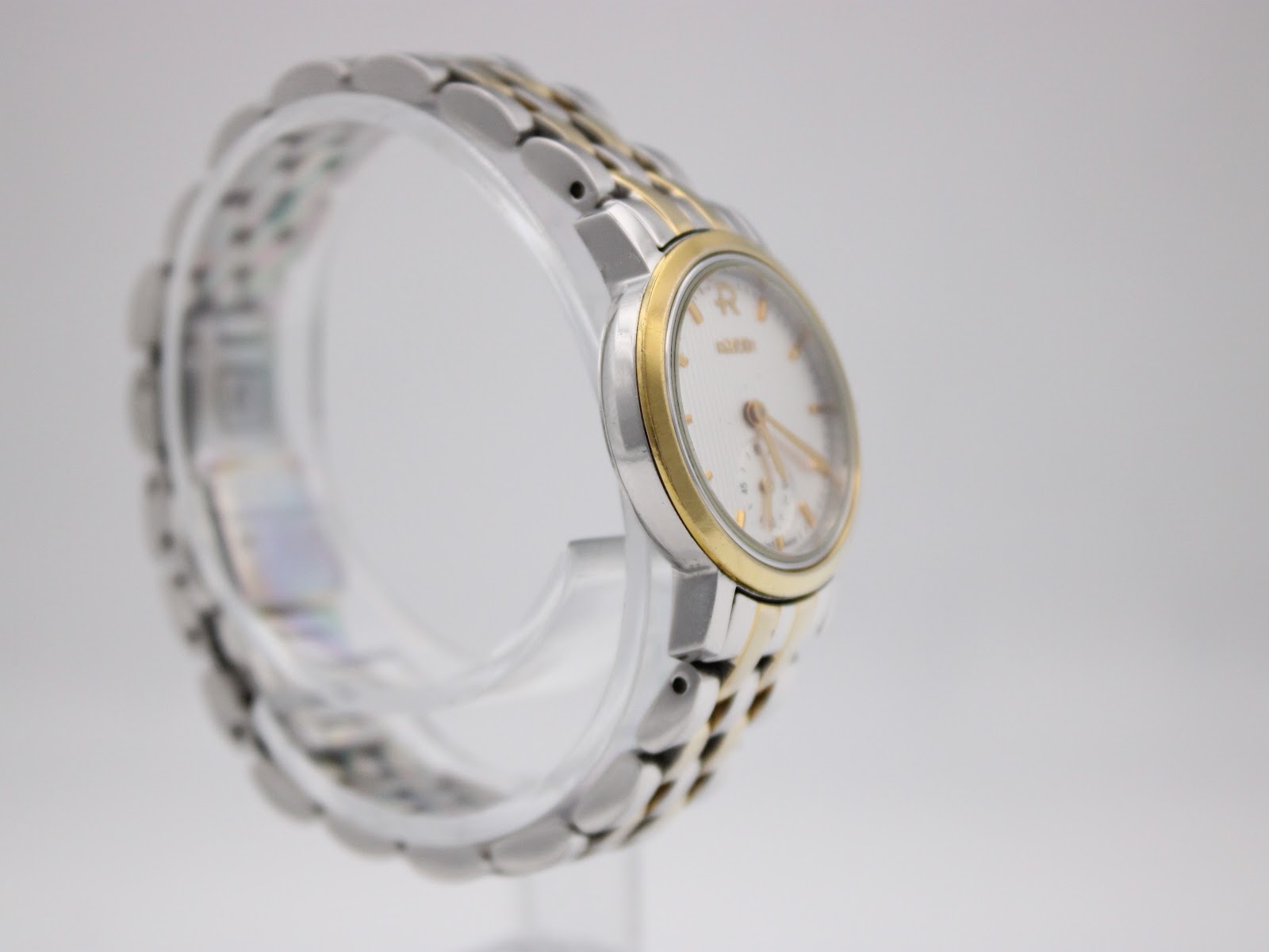 Another side-angle view of the Roamer watch, highlighting the two-tone case details and the integrated bracelet design.