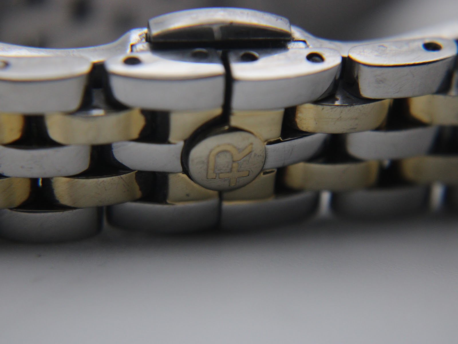 Close-up of the Roamer signed fold-over clasp on the two-tone stainless steel bracelet, showing the 'R' logo.