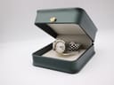 The Roamer watch positioned inside a dark green presentation box with a small gold crown emblem on the lid.
