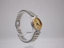 Other angled side view of the Dunhill watch on a clear stand, highlighting case profile and two-tone bracelet.