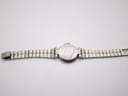 Dunhill watch with two-tone bracelet laid flat, showing the case back.