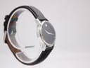 Another angled side view of the Movado Museum watch, emphasising the sleek lines of the case and the simple, elegant dial.