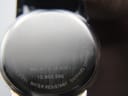 Close-up of the polished stainless steel case back, showing engraved reference number MO.01.3.14.6001 and 'water resistant sapphire crystal' text.