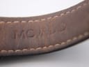 Close-up of the brown inner side of the black leather strap, clearly showing the debossed 'MOVADO' branding.