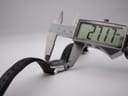 Digital caliper measuring the case diameter of the watch, displaying the precise measurement of 27.17 mm on its screen.