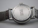 Close-up of the polished stainless steel case back with "Official Swiss Railways Watch" engraving.