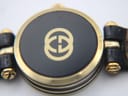 Close-up view of the black case back of the Gucci 2000L, with the gold-tone interlocking G logo and serial number 0000825 visible.