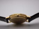 Detailed close-up of the gold-tone crown, featuring the iconic interlocking Gucci 'G' logo.