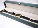 The Gucci 3000.2.M watch presented open in a dark green presentation box with a cream interior lining.