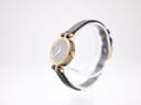 Angled side view of the Gucci 2000L watch on a stand, highlighting the slim gold-plated case and original crown.
