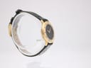 Close-up detail of the dark green leather strap and signed Gucci gold-tone buckle.