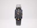 Front view of gold-plated Raymond Weil Othello with black dial and gold roman numeral bezel