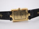 Close-up of the gold-plated case back, showing 'Raymond Weil Genève 18K gold electroplated water resistant 154'