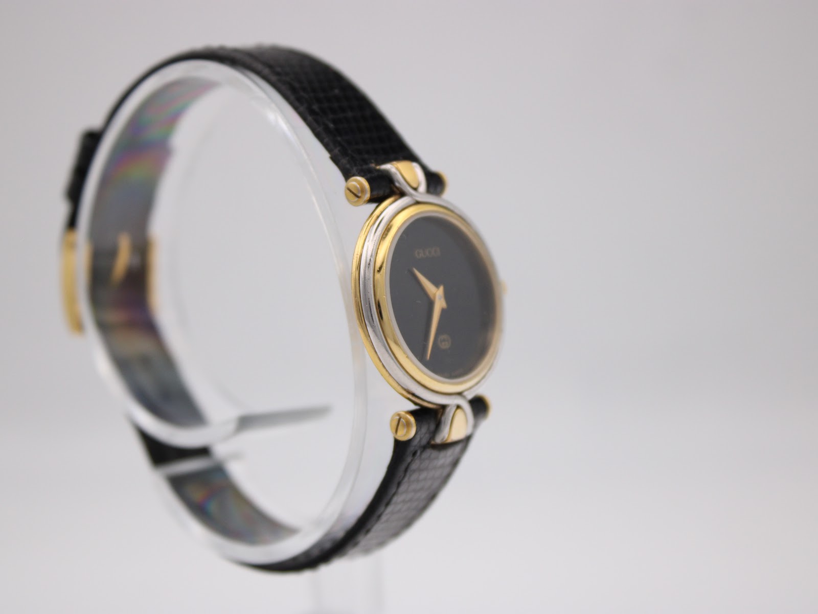 Another angled side view of the Gucci 4500L watch, highlighting the minimalist dial and case design.