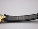 Close-up of the black leather strap interior, showing the embossed 'GUCCI®' logo.