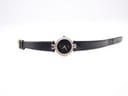 Full length view of the Gucci 4500L watch with its black leather strap laid flat on a white surface.