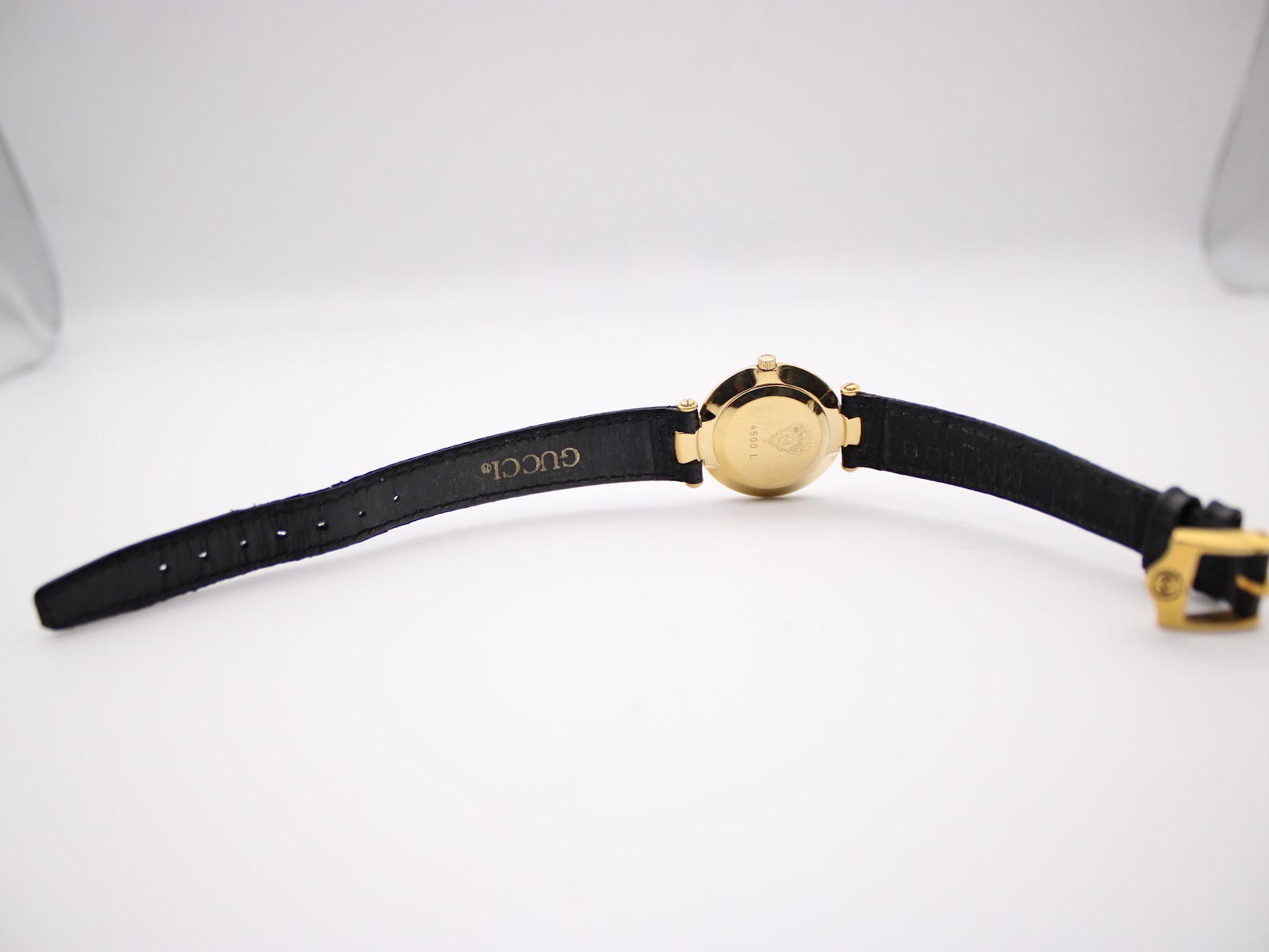 Full length back view of the Gucci 4500L watch, showcasing the case back and the strap with its buckle.